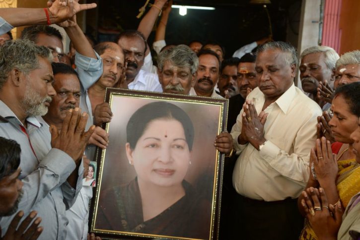Supporters hold a photograph of Tamil Nadu state leader Jayalalithaa Jayaram as they offer prayers for her well being at a temple in Mumbai on December 5, 2016. The ailing chief minister of southern India's Tamil Nadu state, Jayalalithaa Jayaram, who has been hospitalised for the last few months in Chennai, has suffered a cardiac arrest only days after she handed many of her responsibilities to a deputy because of illness.