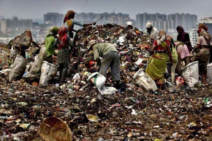 Piles of trash with the National Capital Region New Delhi as the backdrop