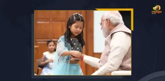 PM Modi Extends Raksha Bandhan Wishes To Indians Celebrates With Young Girls At PM Residence, PM Modi Celebrates Raksha Bandhan with Youngsters at his Residence in New Delhi, Prime Minister Narendra Modi Celebrates Raksha Bandhan with Youngsters at his Residence in New Delhi, Narendra Modi celebrates Raksha Bandhan with daughters of PMO staff, Raksha Bandhan with Youngsters, Prime Minister Narendra Modi, PM Modi, Raksha Bandhan, Raksha Bandhan Wishes, Raksha Bandhan Greetings, 2022 Raksha Bandhan, PM Modi News, PM Modi Latest News, PM Modi Latest Updates, PM Modi Live Updates, Mango News,
